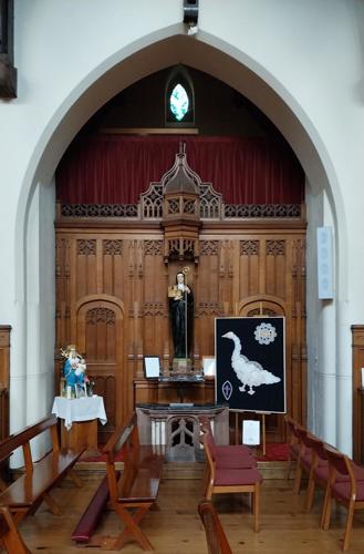 [Shrine with poster board showing goose]